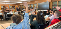 Students raising their hands during the student roundtable event thumbnail240855